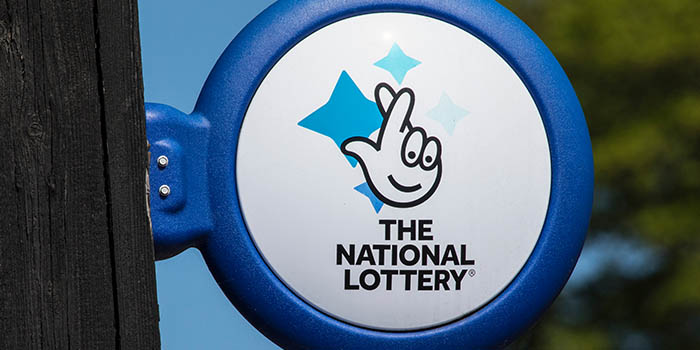 A UK lottery sign under Camelot based outside of a point of sale.